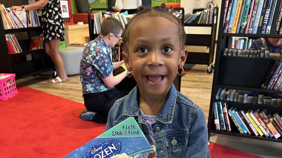 Child holding a Frozen book