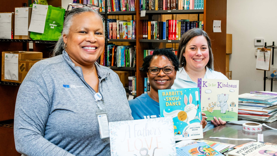 Book Bank leaders holding books